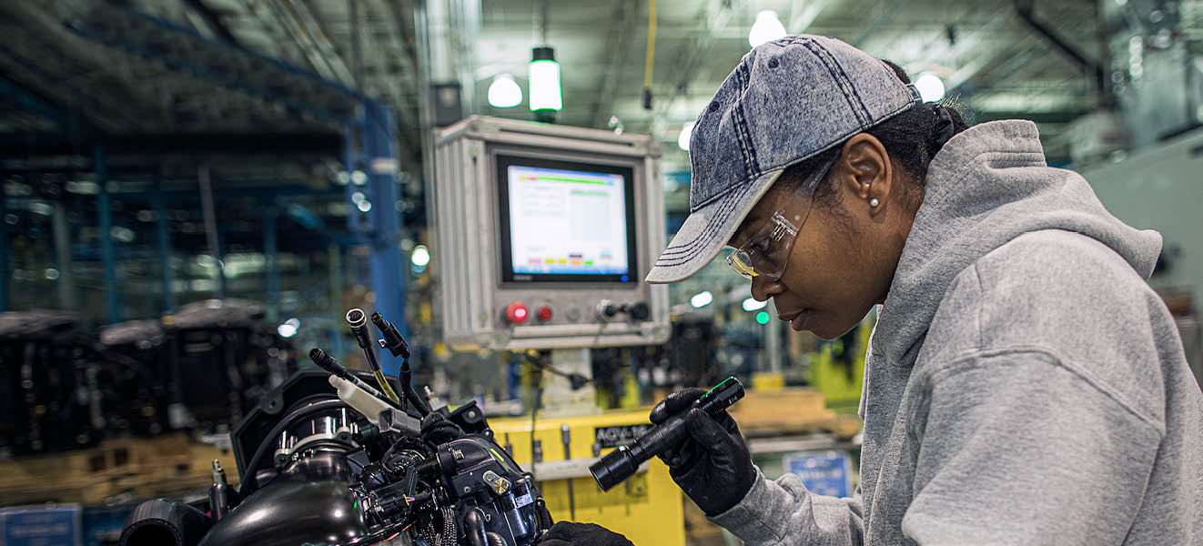 Evinrude employee putting together an outboard engine